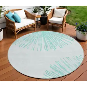 Photo of 8' Aquamarine And Ivory Round Abstract Washable Indoor Outdoor Area Rug