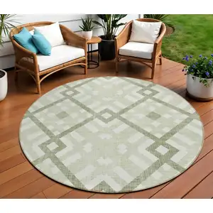 Photo of 8' Artichoke Green And Olive Green Round Geometric Washable Indoor Outdoor Area Rug