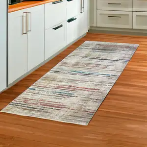 Photo of 8' Beige Geometric Distressed Runner Rug With Fringe