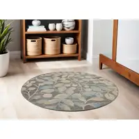 Photo of 5' Beige Gray And Blue Botanical Leaves Round Rug