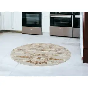 Photo of 4' Beige Round Abstract Washable Non Skid Area Rug With Fringe