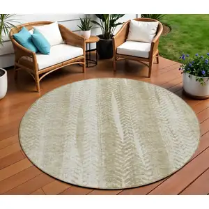 Photo of 8' Beige Tan And Taupe Round Botanical Leaves Washable Indoor Outdoor Area Rug