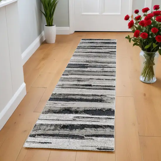 8' Beige and Black Abstract Distressed Runner Rug Photo 1