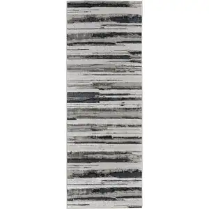 Photo of 8' Beige and Black Abstract Distressed Runner Rug