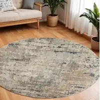 Photo of 10' Beige and Gray Round Abstract Power Loom Area Rug