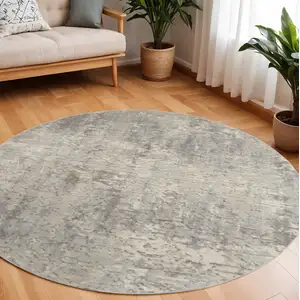 Photo of 8' Beige and Gray Round Abstract Power Loom Area Rug