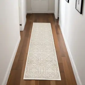 Photo of 7' Beige and Ivory Floral Runner Rug