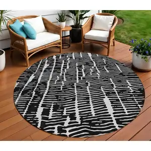 Photo of 8' Black And Ivory Round Abstract Washable Indoor Outdoor Area Rug