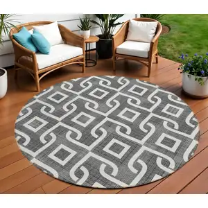 Photo of 8' Black And Ivory Round Geometric Washable Indoor Outdoor Area Rug