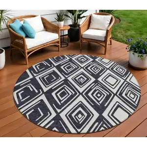 Photo of 8' Black And Ivory Round Geometric Washable Indoor Outdoor Area Rug