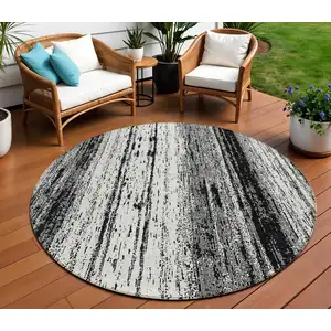 Photo of 8' Black And Ivory Round Striped Washable Indoor Outdoor Area Rug