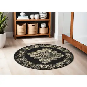 Photo of 4' Black and Tan Medallion Distressed Non Skid Round Rug