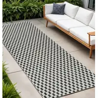 Photo of 10' Black and White Geometric Distressed Indoor Outdoor Runner Rug