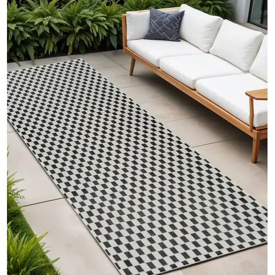 10' Black and White Geometric Distressed Indoor Outdoor Runner Rug Photo 1