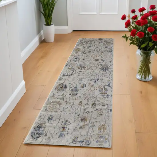 8' Blue Gray and Brown Floral Power Loom Worn Faded Runner Rug With Fringe Photo 1