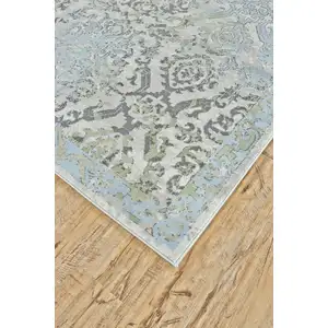 Photo of 8' Blue Gray and Green Floral Power Loom Worn Faded Runner Rug