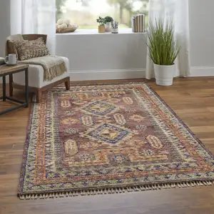 Photo of 12' Blue Red and Tan Wool Geometric Hand Knotted Runner Rug With Fringe