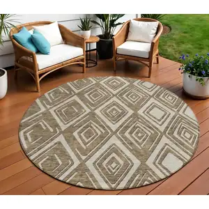 Photo of 8' Brown And Beige Round Geometric Washable Indoor Outdoor Area Rug