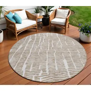 Photo of 8' Brown And Ivory Round Abstract Washable Indoor Outdoor Area Rug