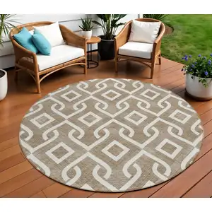 Photo of 8' Brown And Ivory Round Geometric Washable Indoor Outdoor Area Rug