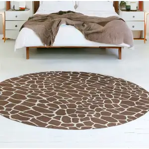 Photo of 8' Brown and Ivory Round Animal Print Handmade Non Skid Area Rug