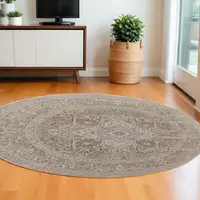 Photo of 8' Brown and Ivory Round Medallion Power Loom Distressed Area Rug