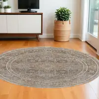 Photo of 8' Brown and Ivory Round Medallion Power Loom Distressed Area Rug