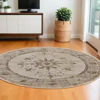 Photo of 8' Brown and Ivory Round Oriental Power Loom Distressed Area Rug