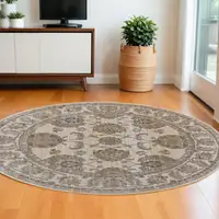 Photo of 8' Brown and Ivory Round Oriental Power Loom Distressed Area Rug