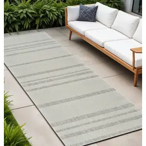 Photo of 10' Cream and Beige Striped Distressed Indoor Outdoor Runner Rug