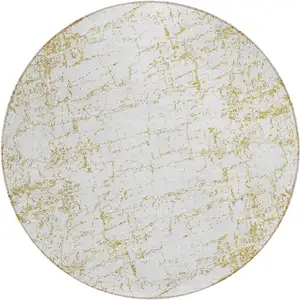 Photo of 8' Gold And Ivory Round Abstract Washable Indoor Outdoor Area Rug