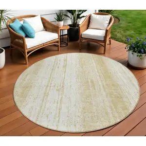 Photo of 8' Gold And Ivory Round Striped Washable Indoor Outdoor Area Rug