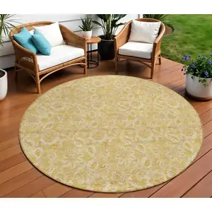 Photo of 8' Gold And Wheat Round Floral Washable Indoor Outdoor Area Rug