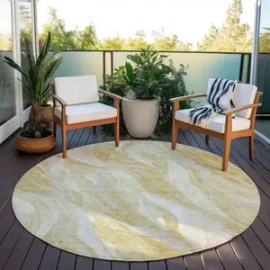 Photo of 8' Gold Beige And Ivory Round Abstract Washable Indoor Outdoor Area Rug