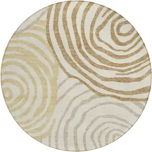 Photo of 8' Gold Ivory And Beige Round Abstract Washable Indoor Outdoor Area Rug