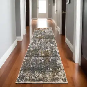 Photo of 8' Gray And Gold Abstract Runner Rug With Fringe