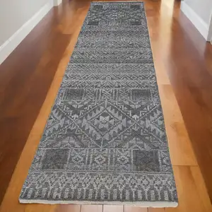 Photo of 10' Gray Ivory and Blue Geometric Hand Knotted Runner Rug With Fringe