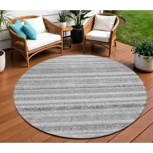 Photo of 8' Gray Silver And Charcoal Round Striped Washable Indoor Outdoor Area Rug