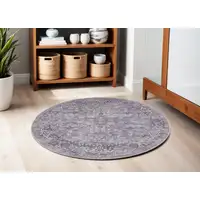 Photo of 5' Gray and Beige Round Floral Power Loom Distressed Area Rug