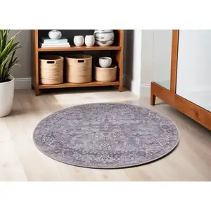 Photo of 5' Gray and Beige Round Floral Power Loom Distressed Area Rug