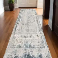 Photo of 13' Gray and Ivory Abstract Distressed Runner Rug