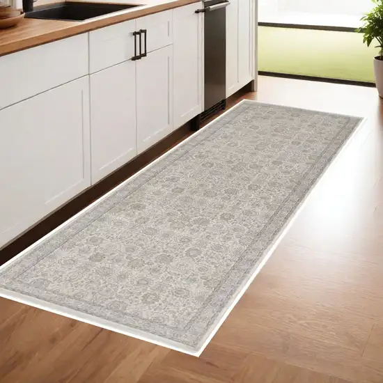 8' Gray and Ivory Oriental Power Loom Worn Faded Runner Rug With Fringe Photo 1