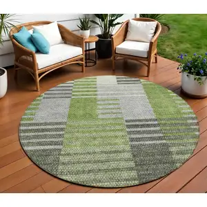 Photo of 8' Green And Olive Green Round Striped Washable Indoor Outdoor Area Rug