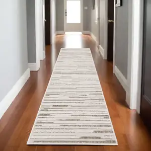 Photo of 8' Ivory And Brown Striped Distressed Runner Rug