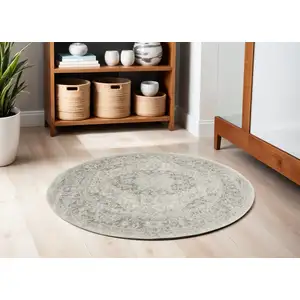 Photo of 5' Ivory And Gray Floral Medallion Distressed Round Rug