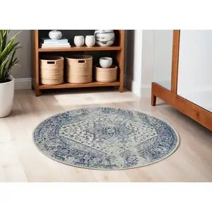 Photo of 5' Ivory And Light Blue Floral Medallion Distressed Round Rug