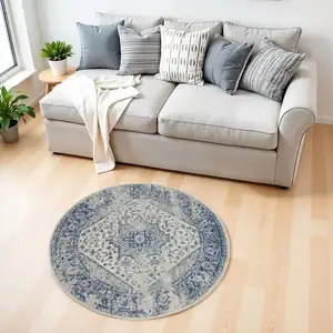 Photo of 4' Ivory And Light Blue Floral Medallion Distressed Round Rug