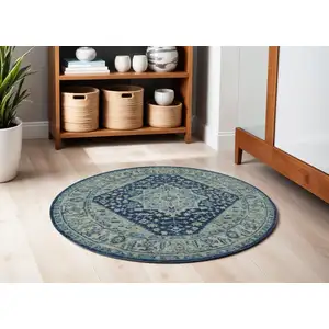 Photo of 5' Ivory And Navy Blue Floral Medallion Distressed Round Rug