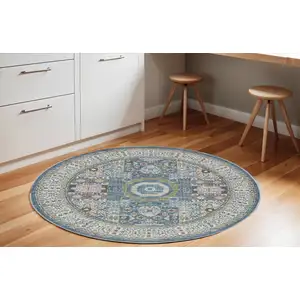 Photo of 6' Ivory Blue and Green Oriental Distressed Non Skid Round Rug