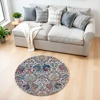 Photo of 4' Ivory Blue and Yellow Floral Distressed Non Skid Round Rug